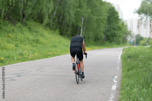 a road bike with a cyclist pedaling on a road.