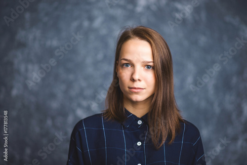 Portrait of a young brunette with sad and serious