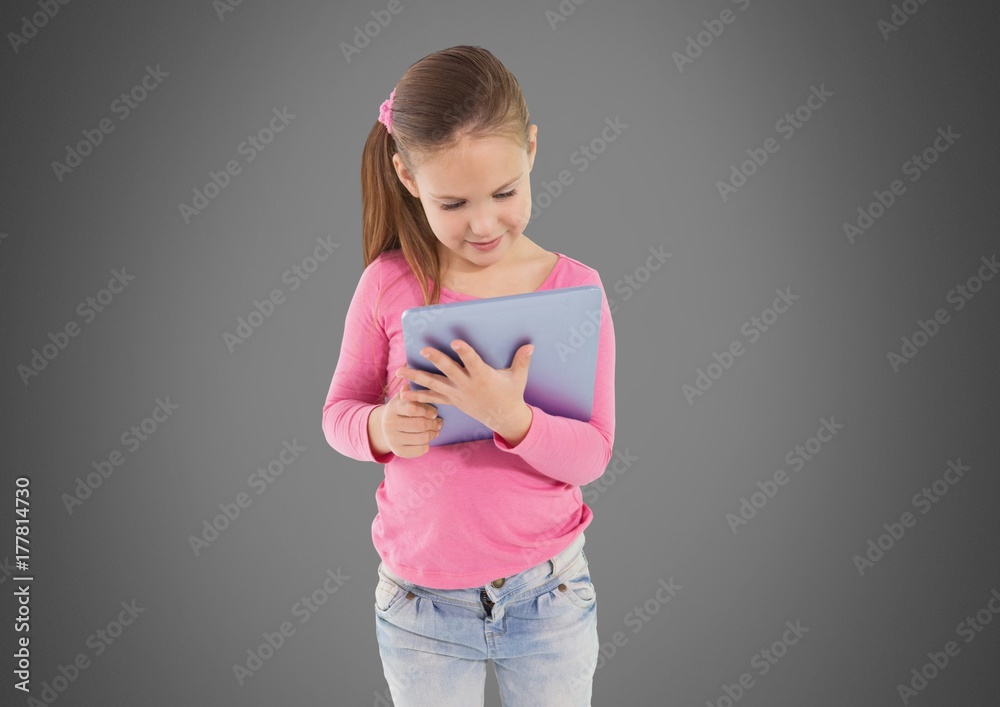 Fototapeta premium Girl against grey background with tablet