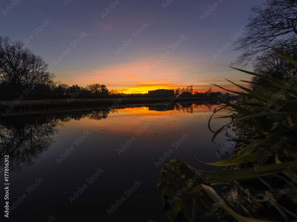 Colorful sky at sunrise reflected in the water of the river Colorful sky at sunrise reflected in the water of the river