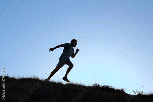 Running man silhouette at sunset