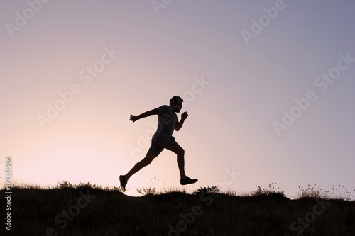 Running man silhouette at sunset