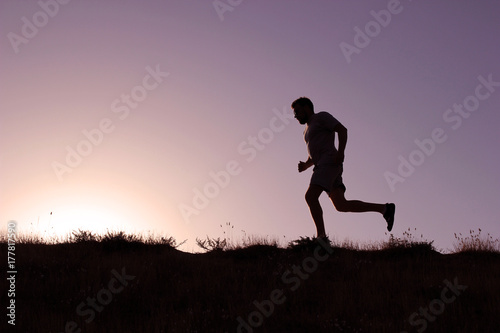 Running man silhouette at sunset