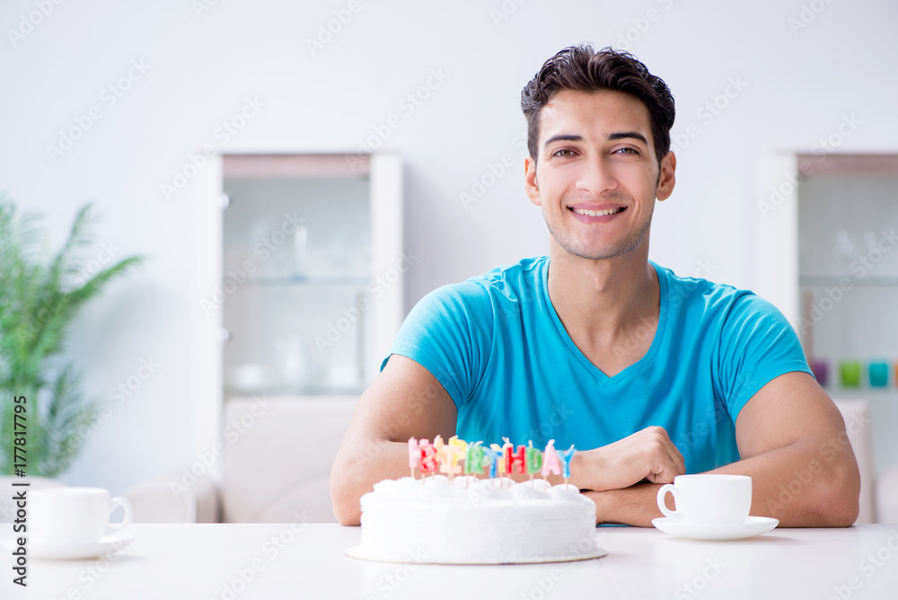 Young man celebrating birthday alone at home Young man celebrating birthday alone at home