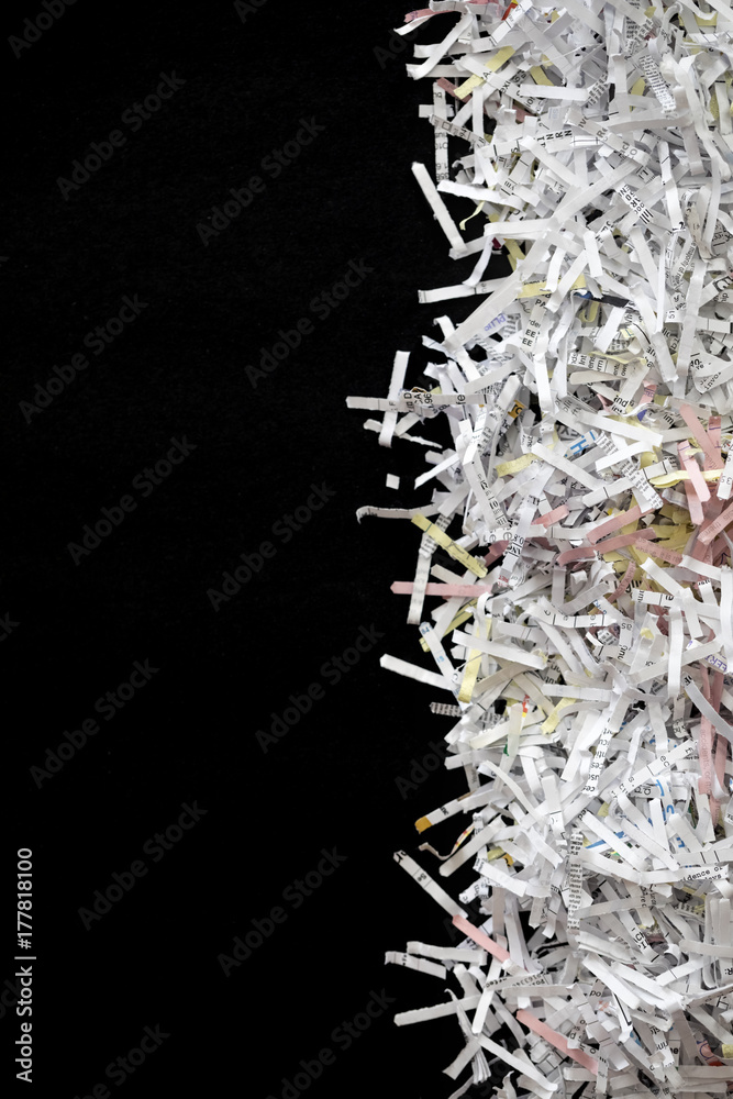 Shredded documents over black background Shredded documents over black background