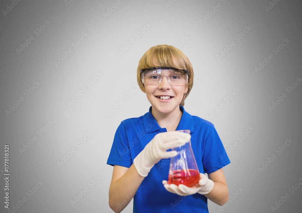 Boy against grey background with science equipment Boy against grey background with science equipment
