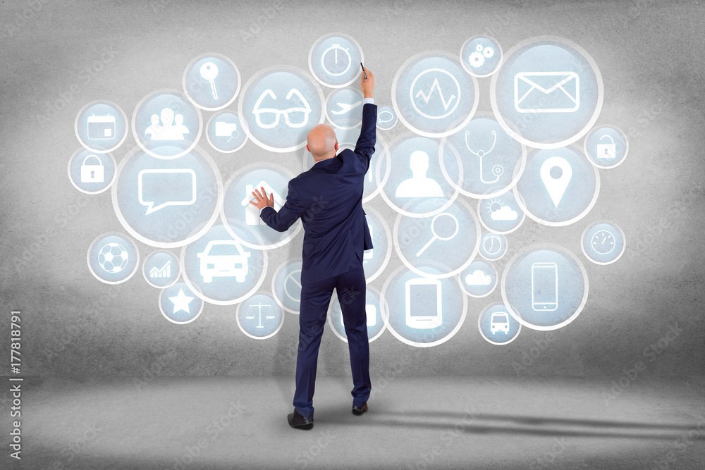 Businessman in front of an interface of different mixed application - technology concept Businessman in front of an interface of different mixed application - technology concept