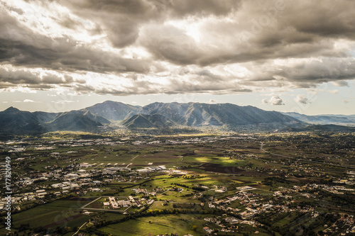 Aerial view of an Italian countryside with a dramatic and cloudy sky. photo