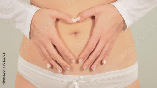 Wallpaper Mural A pregnant woman shows heart shape out of their hands Torontodigital.ca