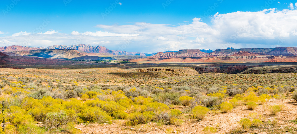 Fototapeta Panorama of desert, mountains with plateaus against blue sky with clouds