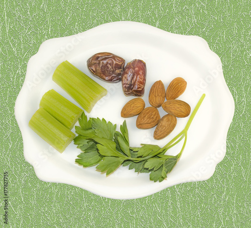 Types of vegetarian food on beautiful plate. Isolated on patterned background