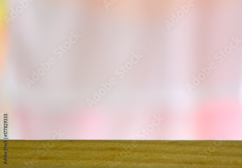 empty wooden table on a background of pastel delicate light pink blurry background. Soft focus.