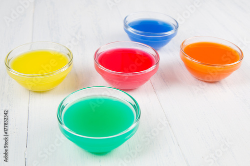 colored liquid on a white wooden background