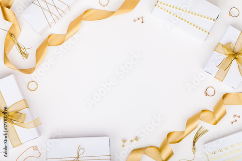 golden jewelry and gift boxes on white background with copy space for text. fashion and shopping concept. wedding, marriage or birthday composition. flat lay, top view