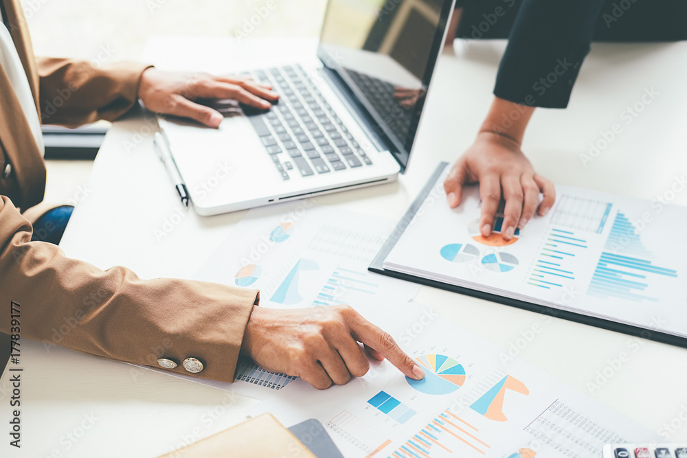 Business concept. Business people discussing the charts and graphs showing the results of their successful teamwork. Business concept. Business people discussing the charts and graphs showing the results of their successful teamwork.