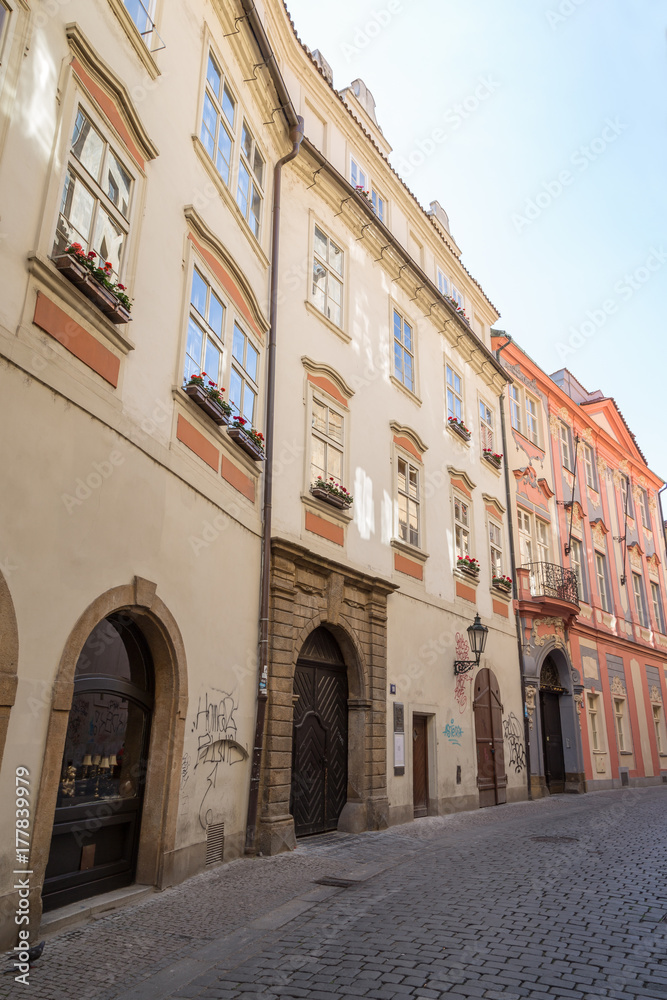 Empty cobblestone street and old and beautiful buildings at the Old Town in Prague, Czech Republic.