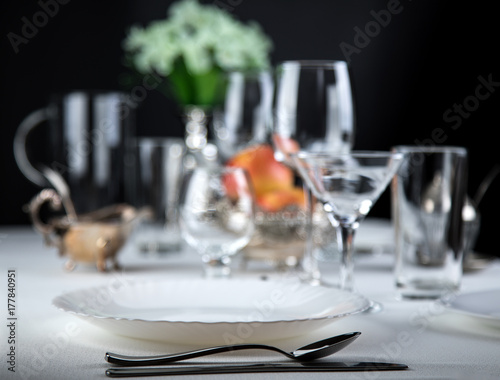 apples on a festive table with glasses and cutlery