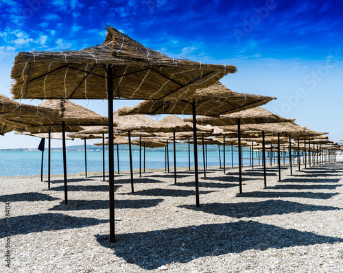 Fototapeta Naklejka Na Ścianę i Meble -  Horizontal vivid beach umbrellas background backdrop