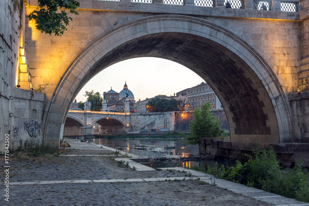 Amazing Sunset view of Tiber River, St. Angelo Bridge and St. Peter's Basilica in Rome, Italy