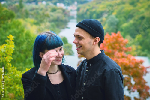 Young couple in black shirts smiling