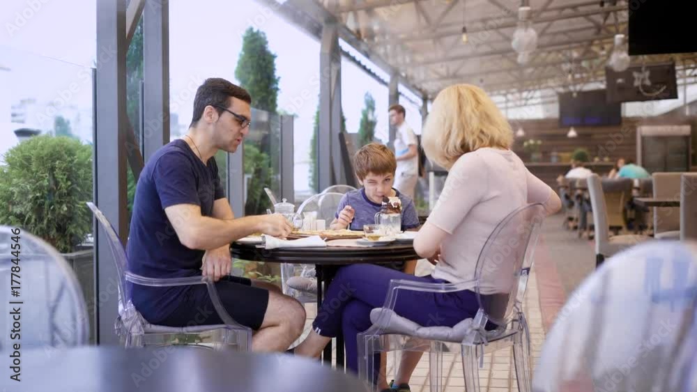 Family with son eating out together on terrace of restaurant. Family with son eating out together on terrace of restaurant.