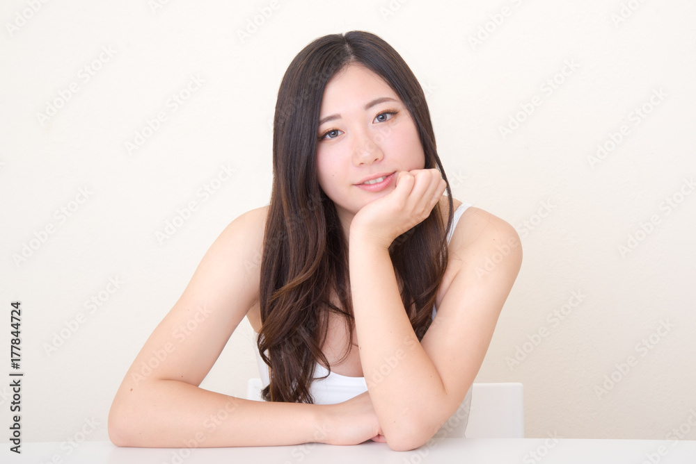 young asian woman posing at table young asian woman posing at table