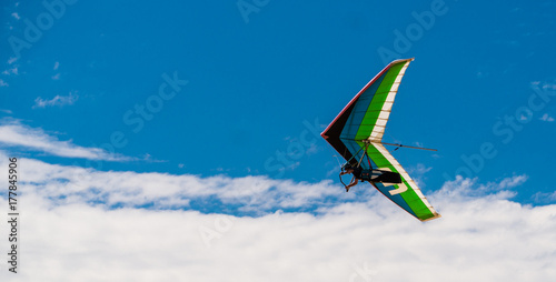 Hang Glider flying in blue sly