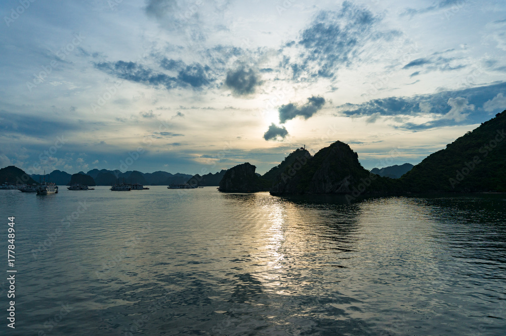 Dusk at Halong Bay with dark mountain island silhouettes