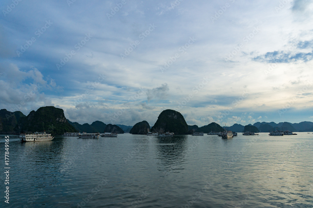 Dusk at Halong Bay with dark mountain island silhouettes
