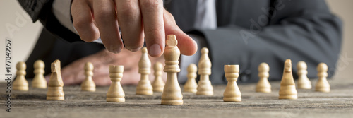 Wide cropped image of a businessman playing chess photo