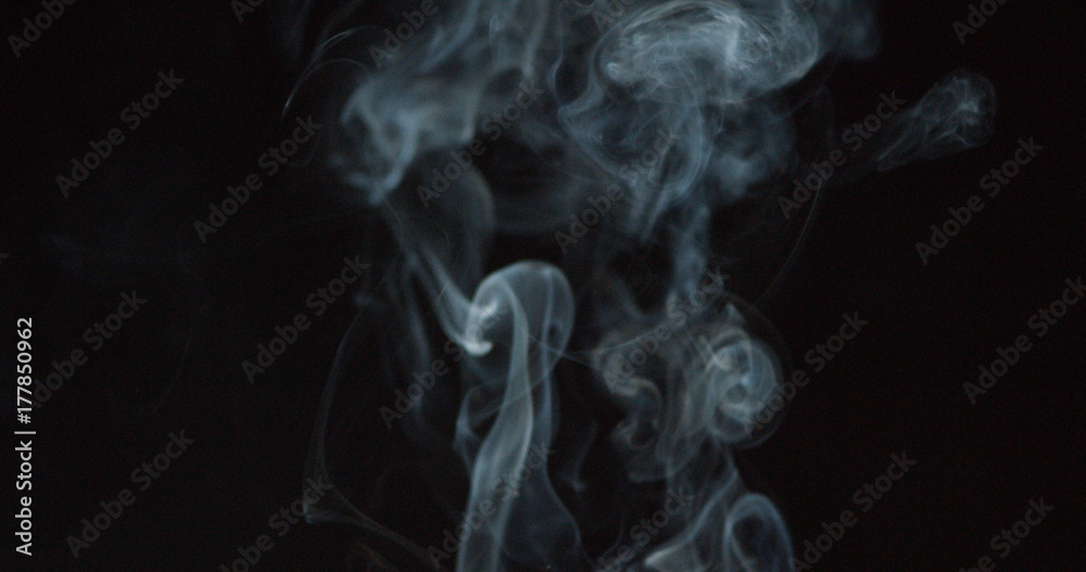 Puffing white smoke over a dark background Puffing white smoke over a dark background
