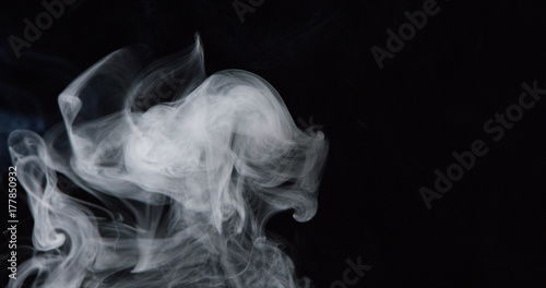 Billowing cloud of white smoke against dark background 2