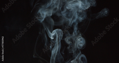 Puffing white smoke over a dark background