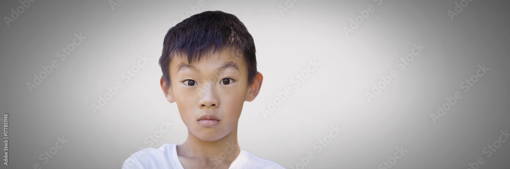 Boy against grey background with bewildered stunned expression Boy against grey background with bewildered stunned expression