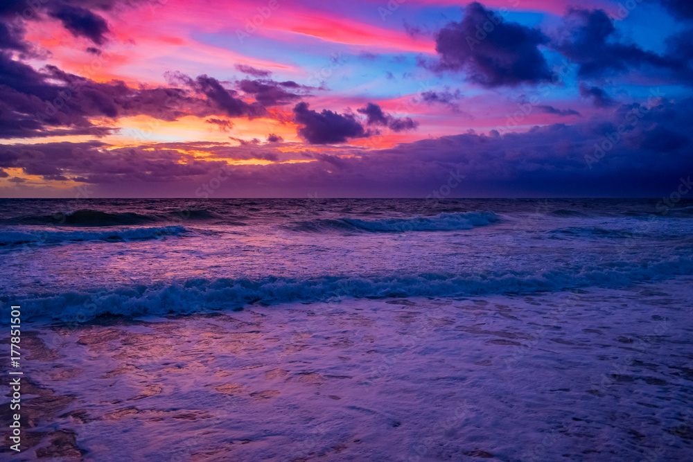 bright pink blue and orange sunrise over the ocean