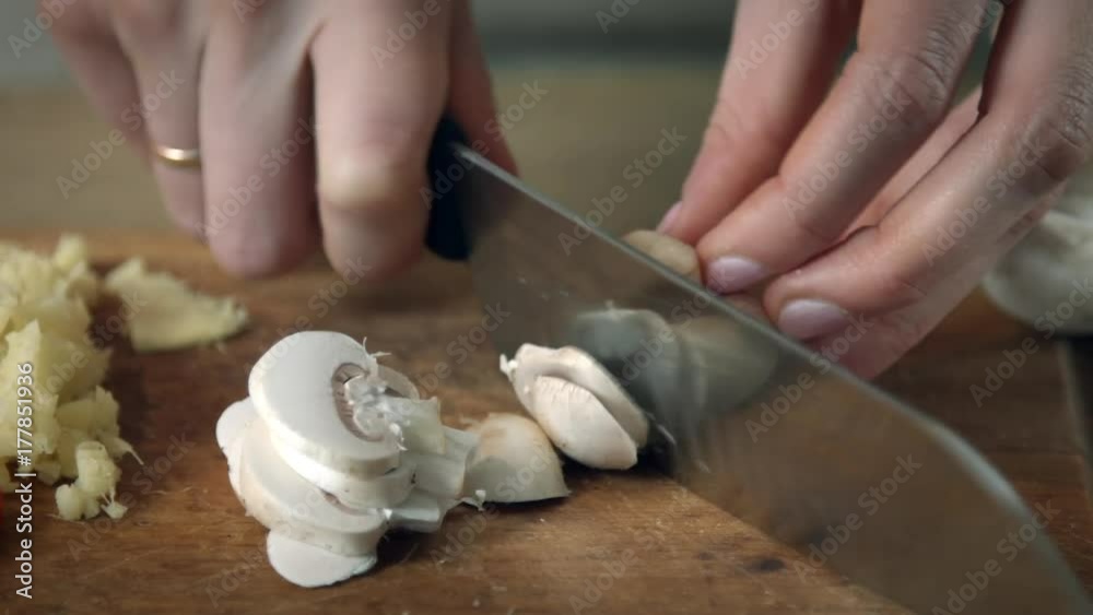 Chef cutting mushrooms close up shot Chef cutting mushrooms close up shot