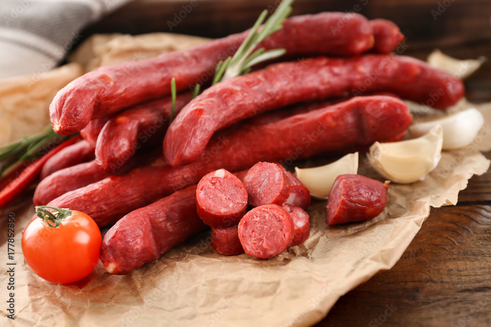 Delicious smoked sausages on parchment Delicious smoked sausages on parchment