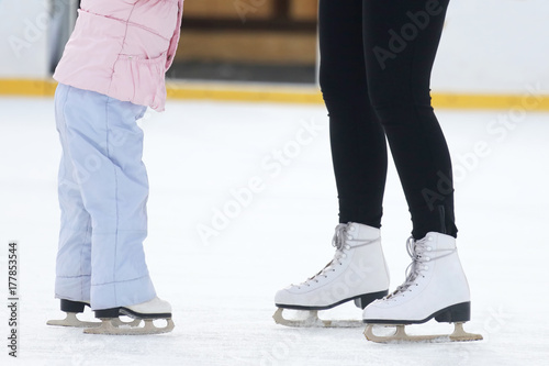 the legs of a man skating on an ice rink