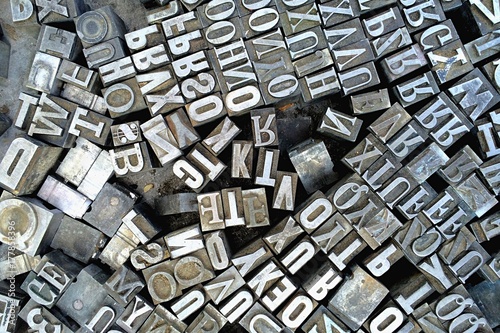 Old antique metal printing letters from a printing press photo