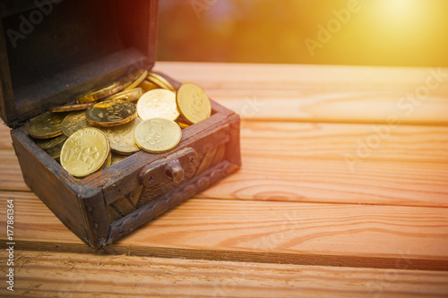 A box of coin over the wooden table