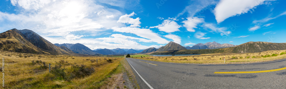Rural Scene of Asphalt Road with Meadow and Mountain Range, South Island, New Zealand Rural Scene of Asphalt Road with Meadow and Mountain Range, South Island, New Zealand