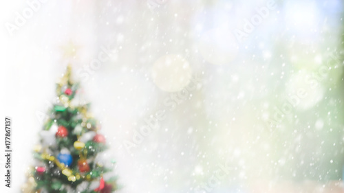 Blurred bokeh christmas tree with snowfall background for your text or advertising. photo