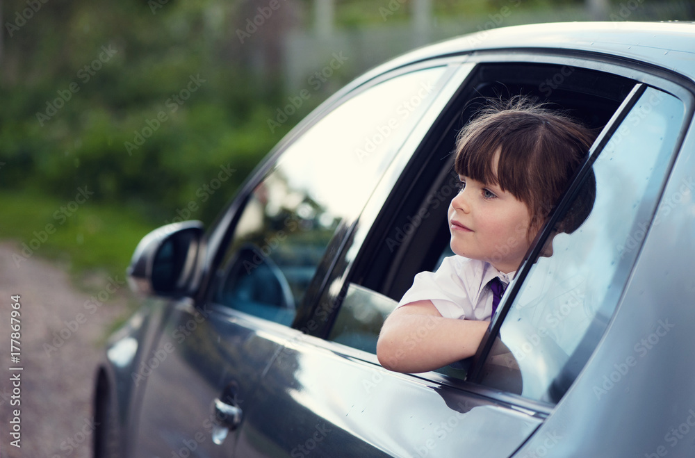Little girl looking out of a car window Little girl looking out of a car window