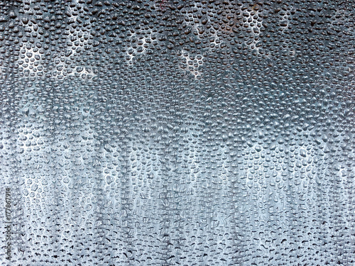 Water droplets from condensation on the inside of a window in winter