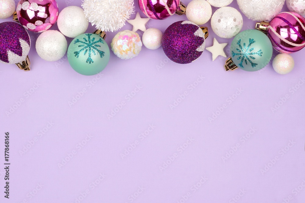 Modern pastel Christmas bauble top border over a light purple background