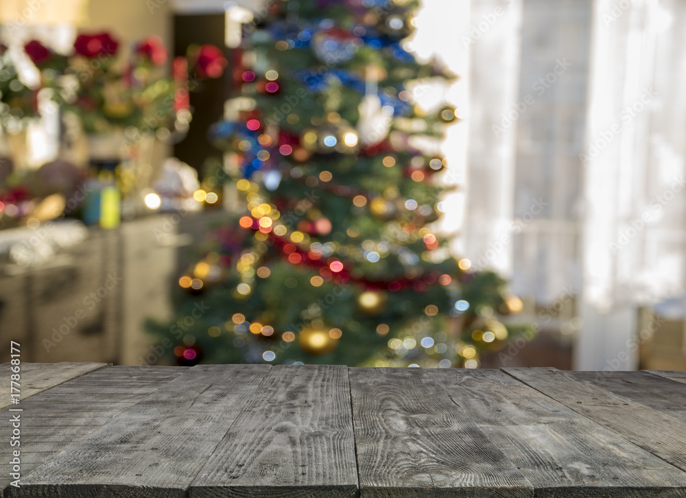 christmas table background with christmas tree out of focus