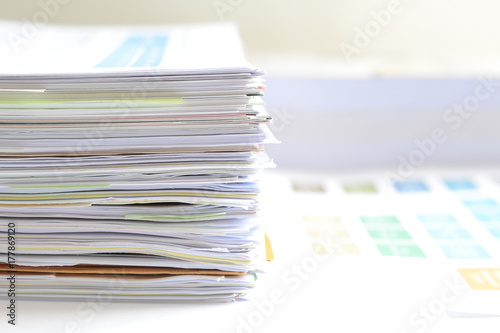 Pile of financial documents on desk at workplace,business concept.
