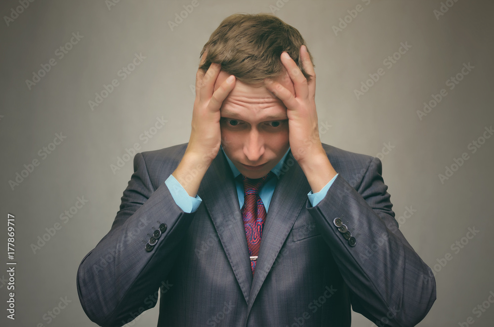 Business man in stress keeps his hands behind his head isolated. Debt. Stress situation. Business man in stress keeps his hands behind his head isolated. Debt. Stress situation.