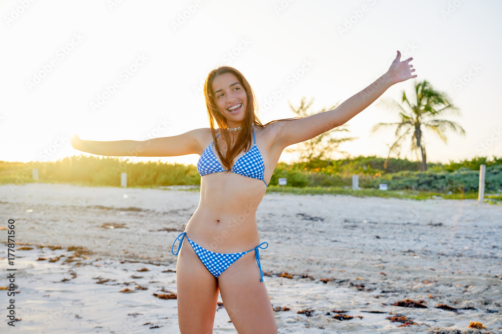 Latin beautiful bikini girl happy in Caribbean