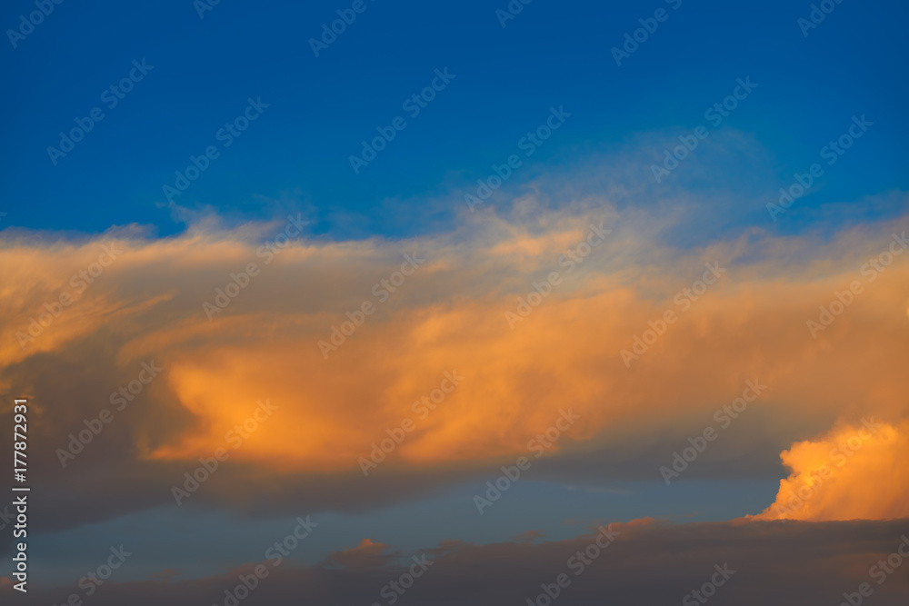 Sunset sky orange clouds on blue